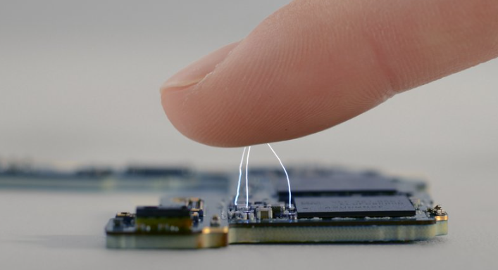 image of mobile phone system with electrostatic discharge from a human finger